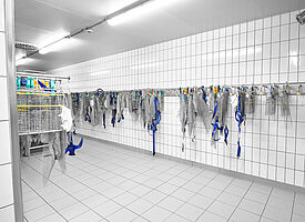 Wall-mounted knife-baskets holder in the meat factory 